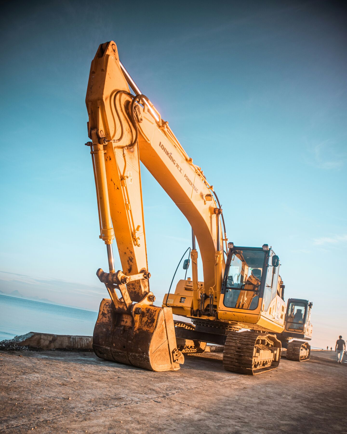 Excavator bucket and hydraulic arm in close-up